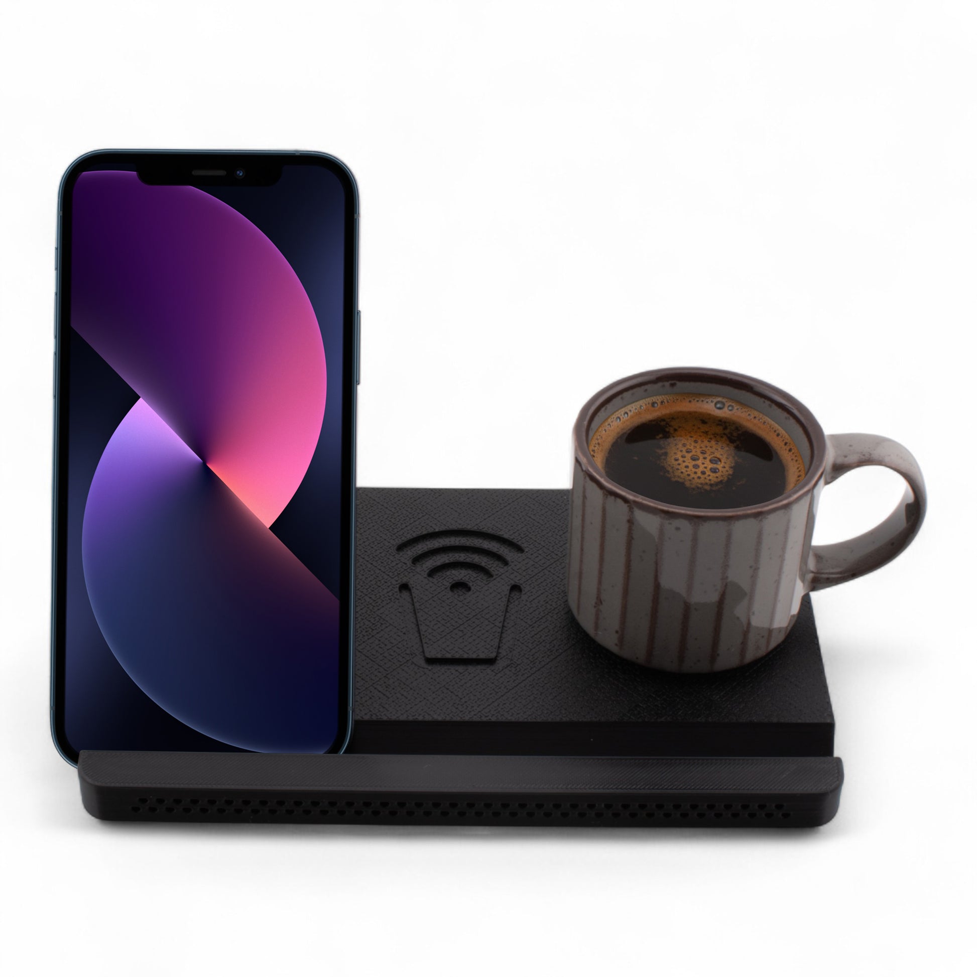 Smartphone and coffee mug on a charcoal coaster on a white background front facing