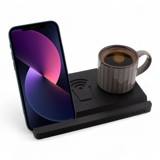 Smartphone and coffee mug on a charcoal coaster on a white background right angle